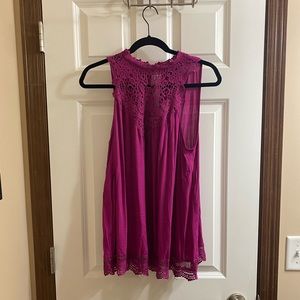 Pink tank with lace embellishment.